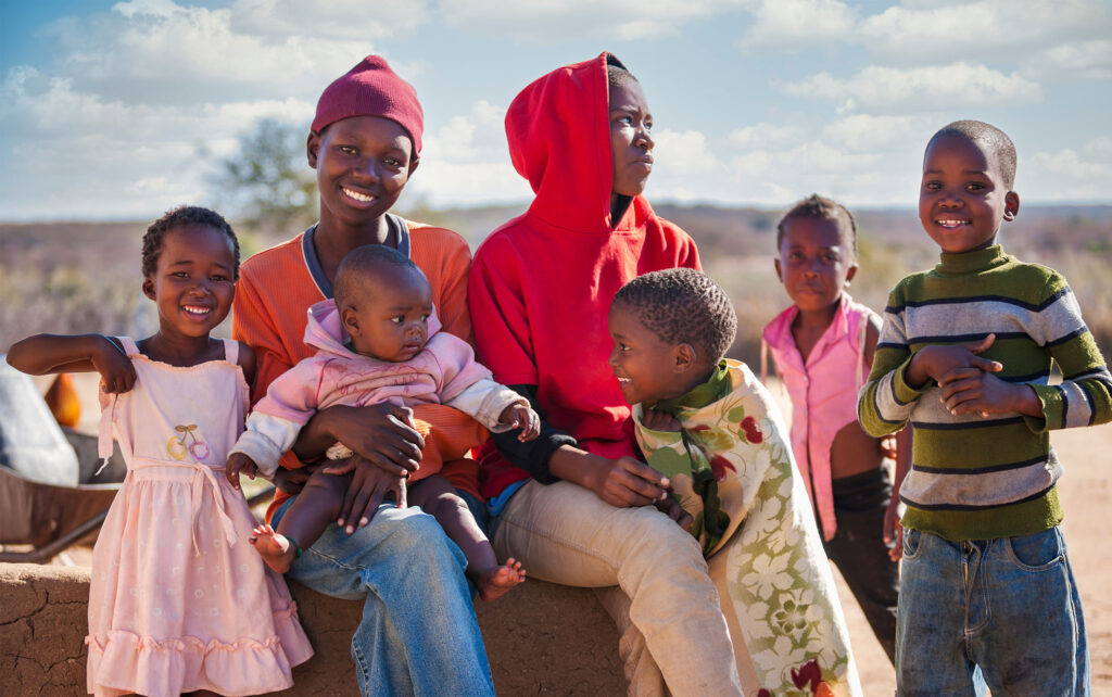 A family laughing and smiling at each other and the camera.