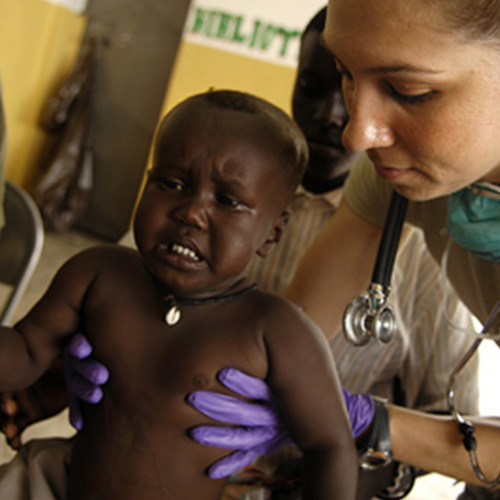 A nurse assisting a baby getting treatment.